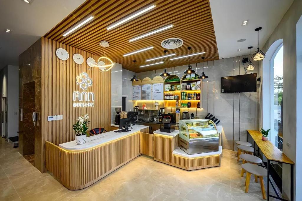 a coffee shop with a counter in a room at Ann Hotel & Spa Phu Quoc in Phú Quốc