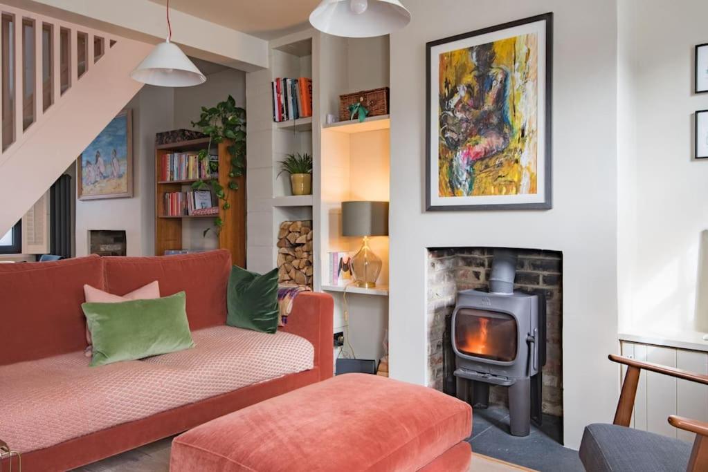 a living room with a couch and a fireplace at Rosewood in Walmer