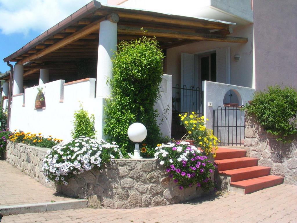 a house with a bunch of flowers in front of it at Villa a Lipari in Lipari