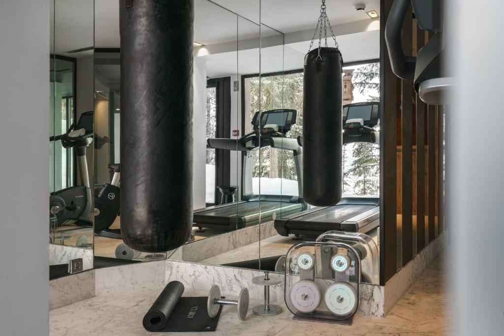 a gym with two punching bags and weights at Hôtel La Sivolière in Courchevel