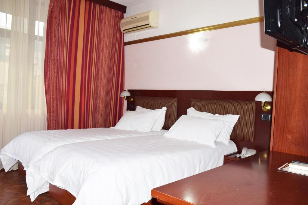 Postel nebo postele na pokoji v ubytování Hotel Elysee