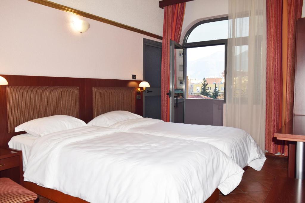 Postel nebo postele na pokoji v ubytování Hotel Elysee