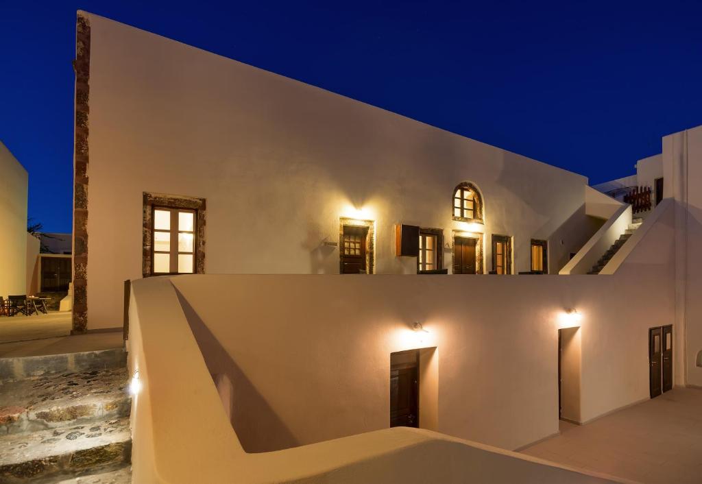 a white house at night with lights at AENAON ESTATE 1896 by K&K in Pyrgos