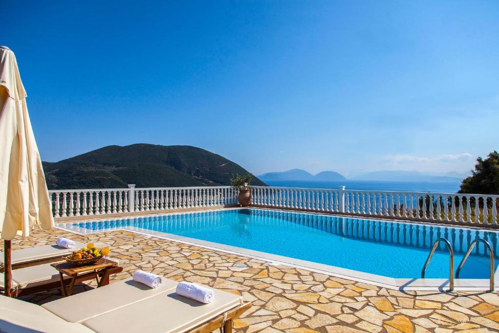 a swimming pool with a view of the mountains at Dream Villa with Seaviews in Vasiliki