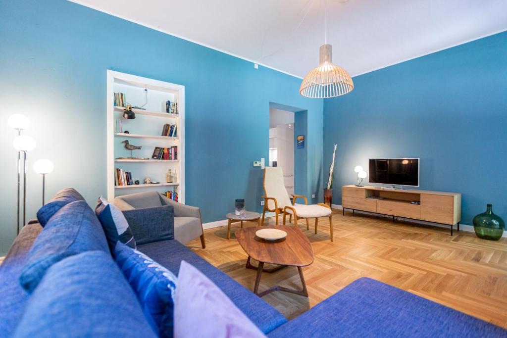 a blue living room with a couch and a table at Haus Silvana in Zempin