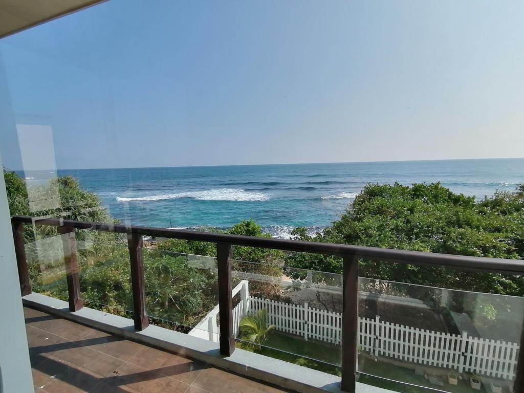 a balcony with a view of the ocean at ARA Beach Resort Mirissa in Mirissa