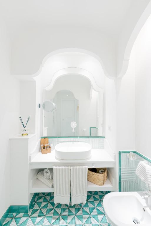 a bathroom with a sink and a mirror at Hotel Cetus in Cetara