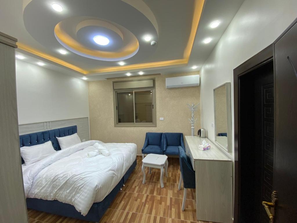 a hotel room with a bed and a desk and a room at Treasury Terrace Apartments in Wadi Musa