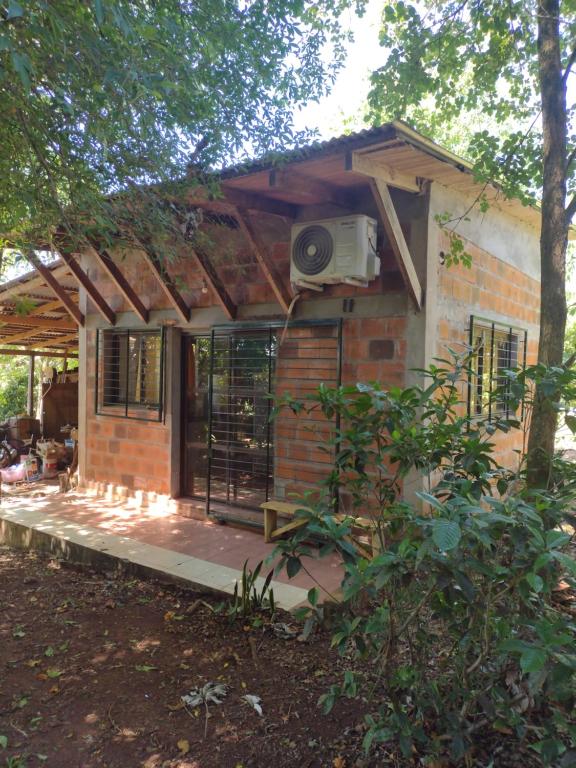 a small brick house with a porch and a balcony at Colibrí Apart in El Soberbio