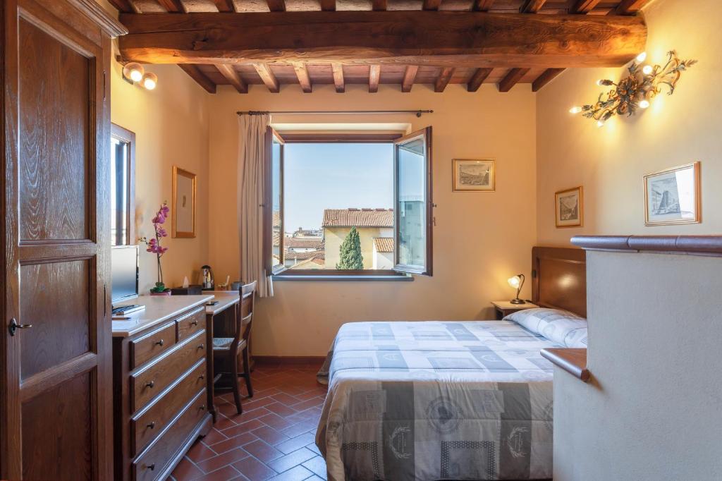 Postel nebo postele na pokoji v ubytování Palazzo Graziani