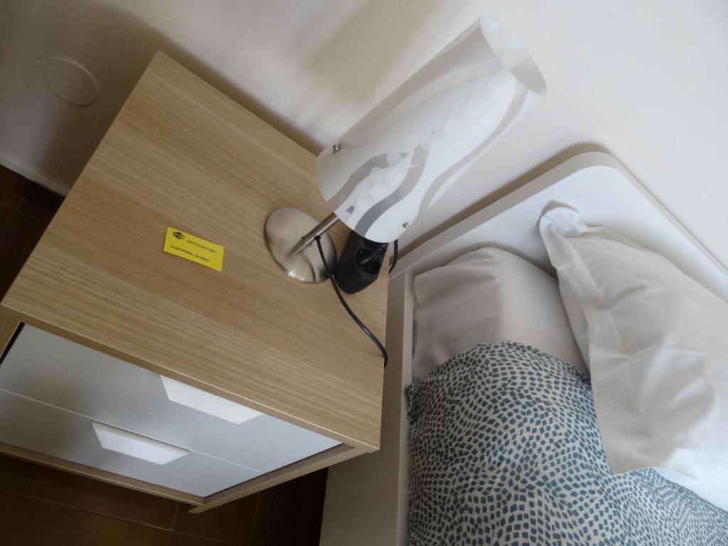 Postel nebo postele na pokoji v ubytování Ostello Cuneo