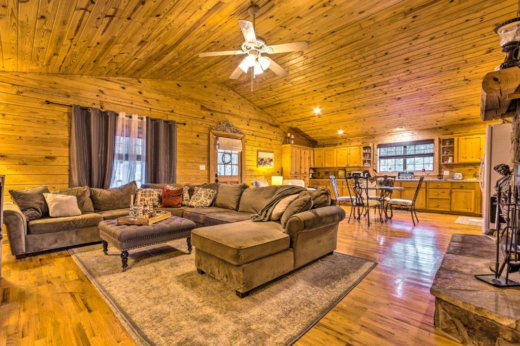 a living room with a couch and a ceiling fan at Pet-Friendly Cabot Cabin with Fenced Yard! in Cabot