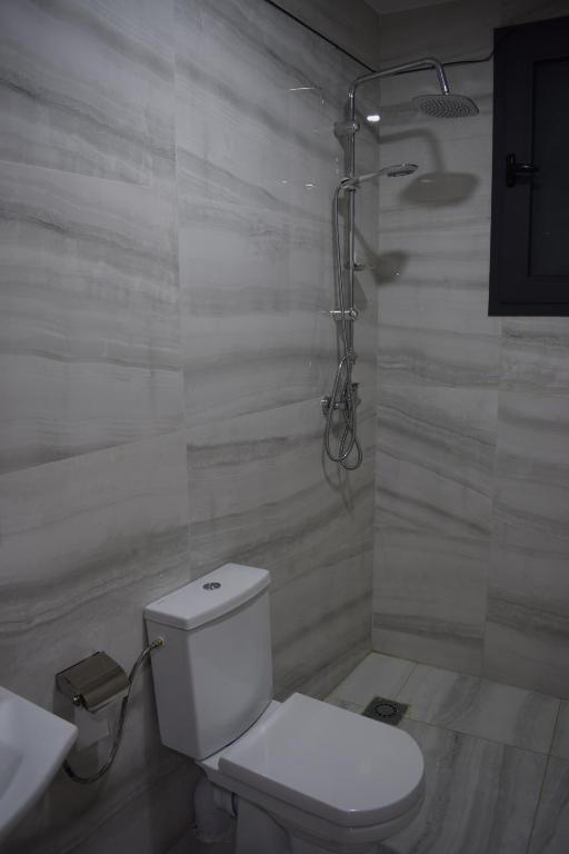 a white bathroom with a toilet and a sink at Moonrise Villa VIP Midelt in Midelt