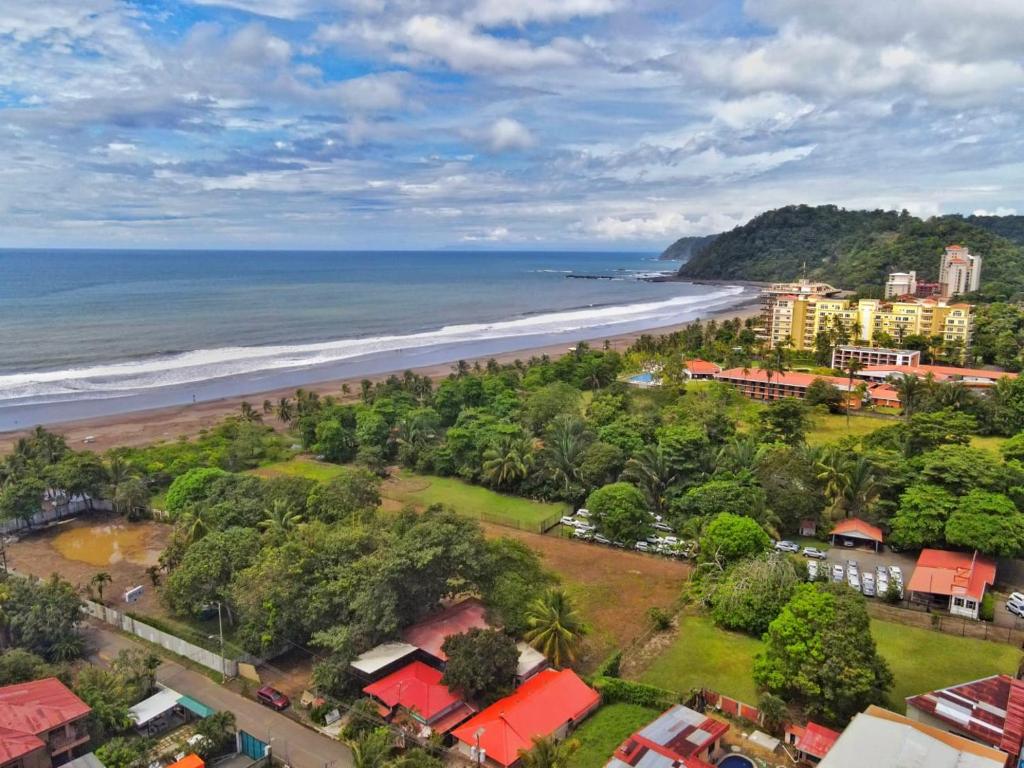 an aerial view of a beach with buildings and the ocean at Condominio Tropical villa 2 in Jacó