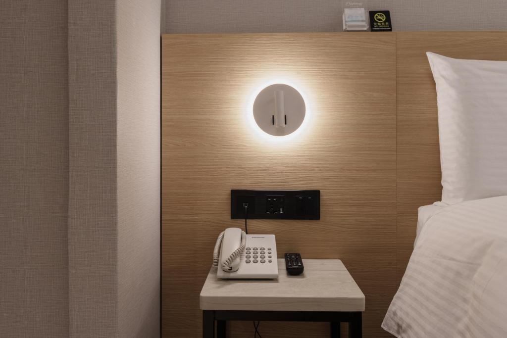 Postel nebo postele na pokoji v ubytování Hubhotel Benqiao Inn Far Eastern Branch