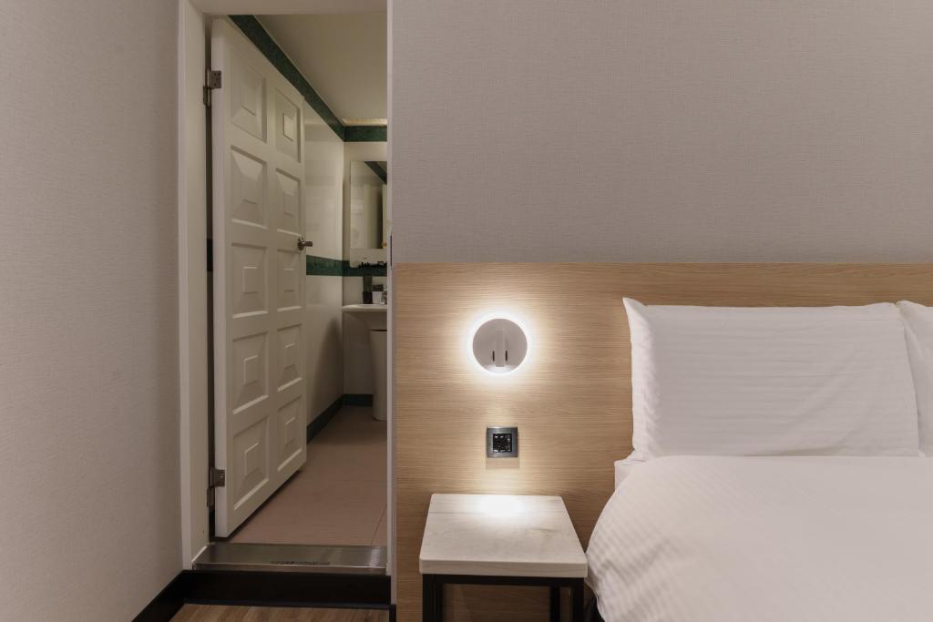 Postel nebo postele na pokoji v ubytování Hubhotel Benqiao Inn Far Eastern Branch