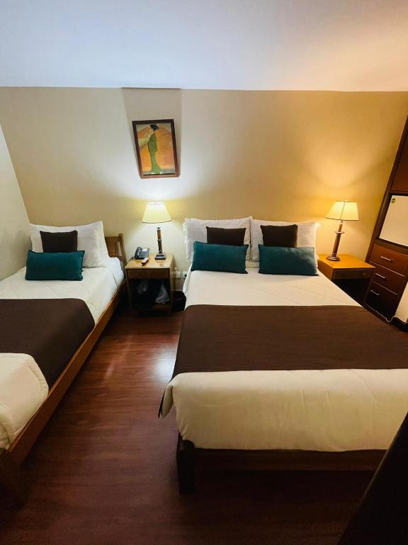 Postel nebo postele na pokoji v ubytování Hotel La Sabana