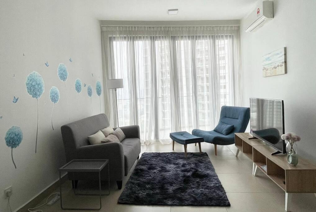 a living room with a couch and two chairs at KL Gateway Premium Residence near to Mid Valley Bangsar in Kuala Lumpur