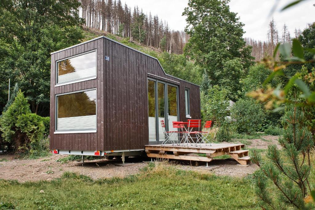 a tiny house sitting on top of a hill at Tiny House Nature 17 - Green Tiny Village Harz in Osterode
