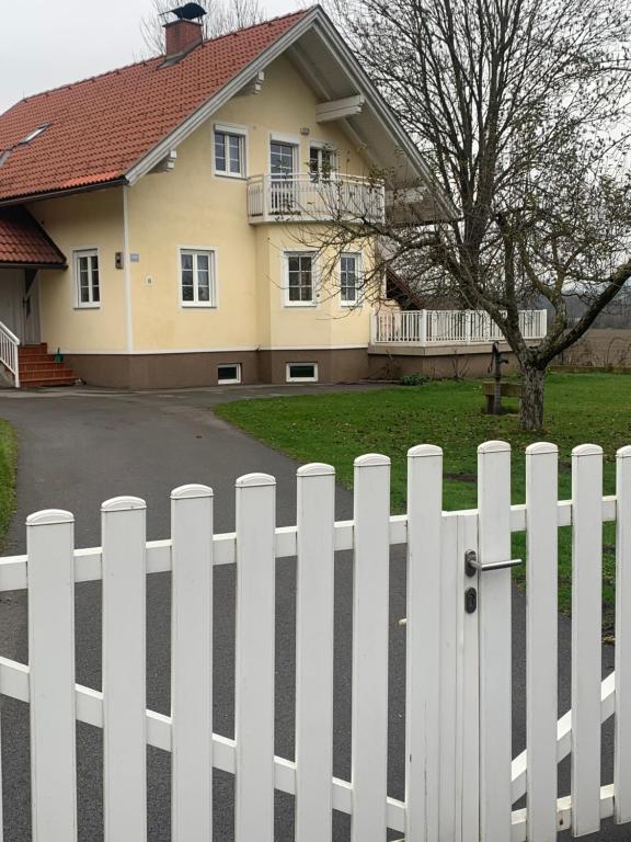 a white picket fence in front of a house at Ferienhaus Loretto in Wölzing