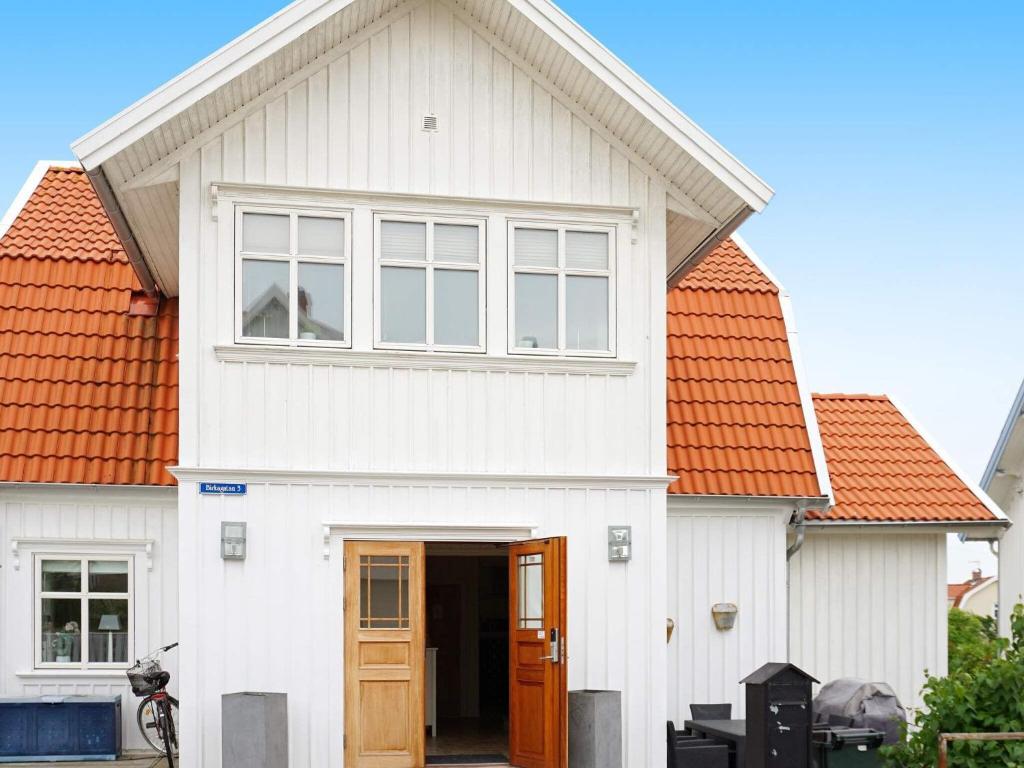 uma casa branca com um telhado laranja em Holiday home KUNGSHAMN III em Kungshamn