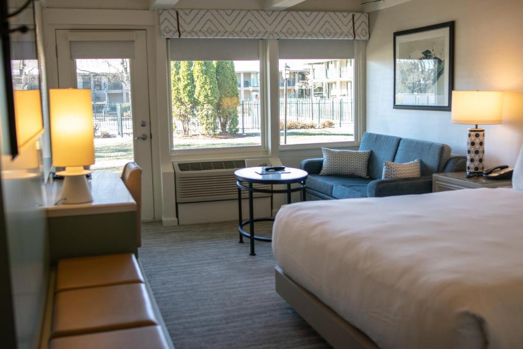 a hotel room with a bed and a couch at The Abbey Resort in Lake Geneva