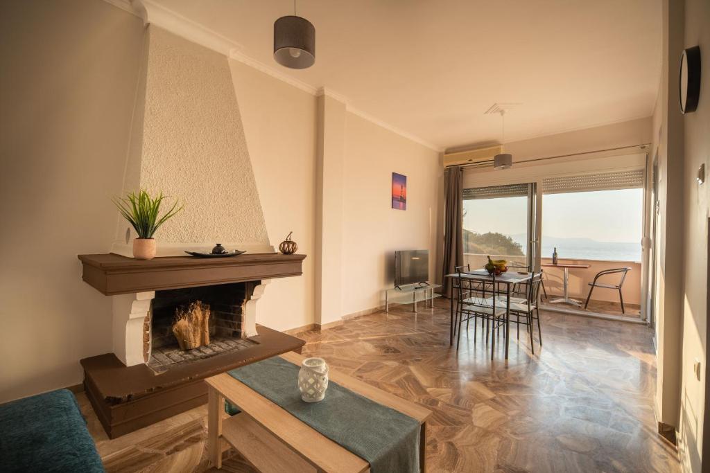 salon z kominkiem i widokiem na ocean w obiekcie Sea Gem w Chanii