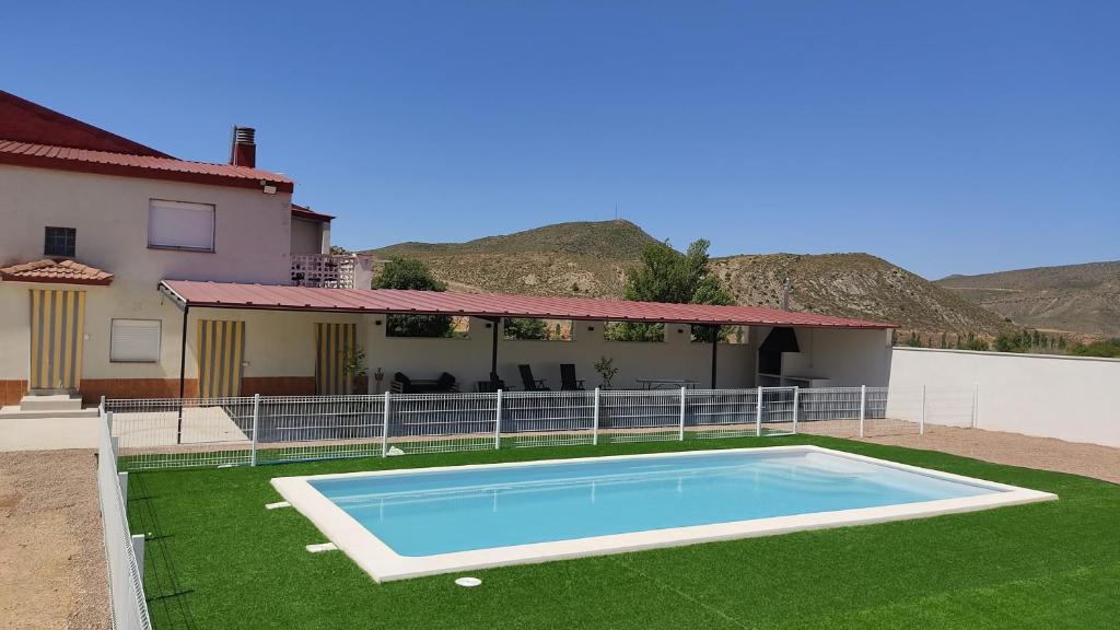 a swimming pool in the yard of a house at Casa en zona rural a 200 m de Ariño (Teruel) in Ariño