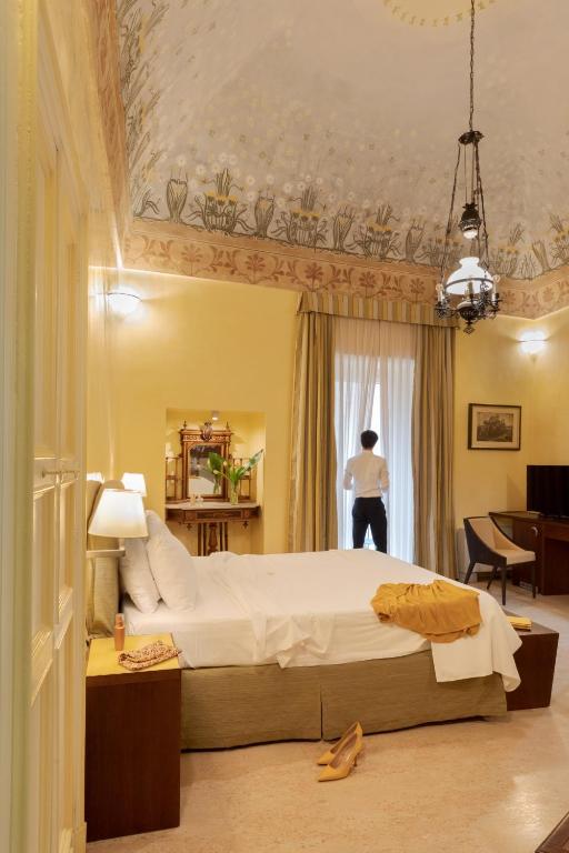 Postel nebo postele na pokoji v ubytování Hotel Palazzo Papaleo