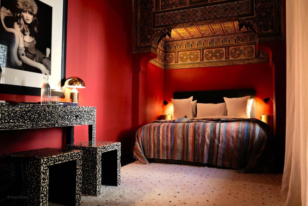 a bedroom with a bed and a red wall at Sakkan in Marrakech