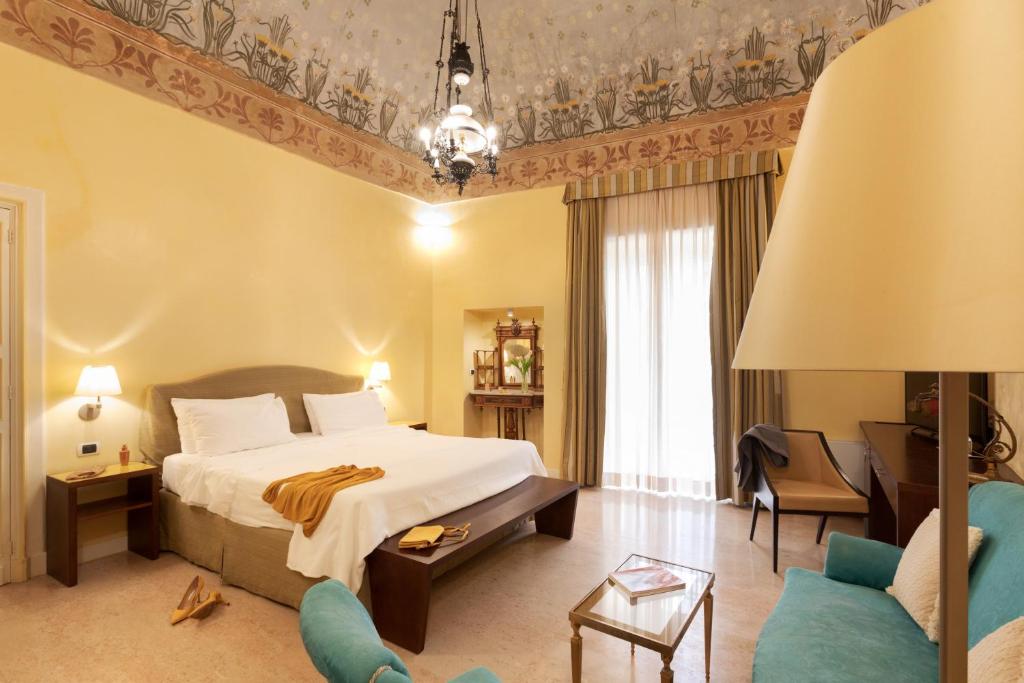 Postel nebo postele na pokoji v ubytování Hotel Palazzo Papaleo