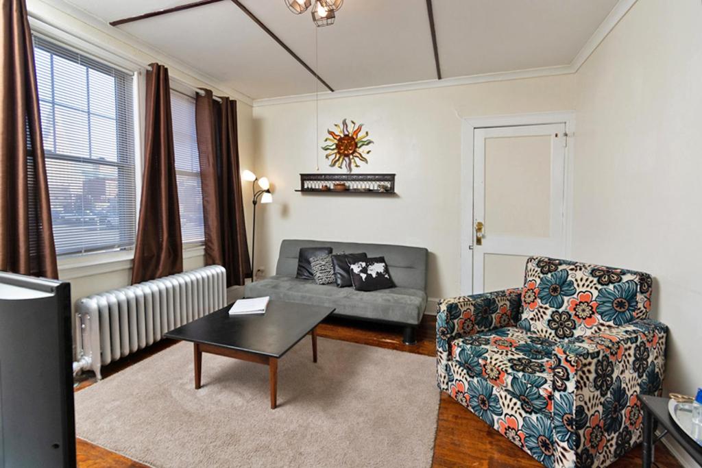 a living room with a couch and a chair at The Wadsworth Suite A2 in Hartford