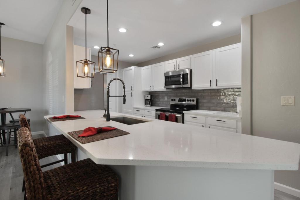 a kitchen with white cabinets and a white counter top at DESERT JEWEL in Tucson