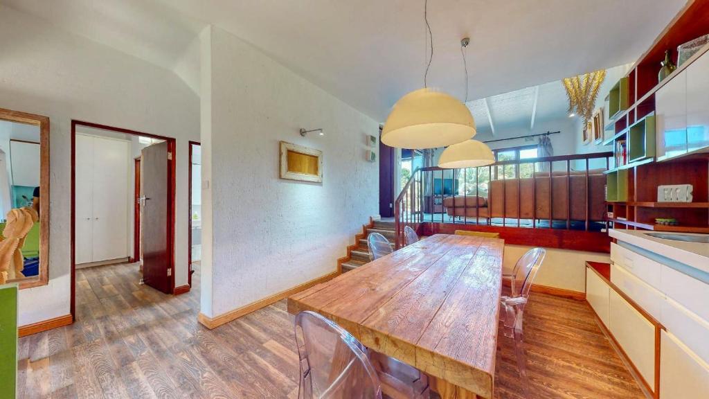 a dining room with a wooden table and chairs at San Lameer Lux by Top Destinations Rentals in Southbroom