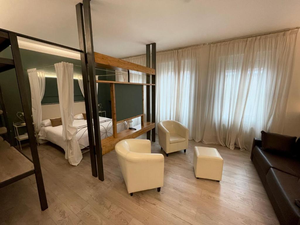 a bedroom with a bed and a living room at Hotel Italia in Verona