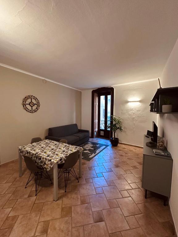 a living room with a table and a couch at La casa del corso in Arona