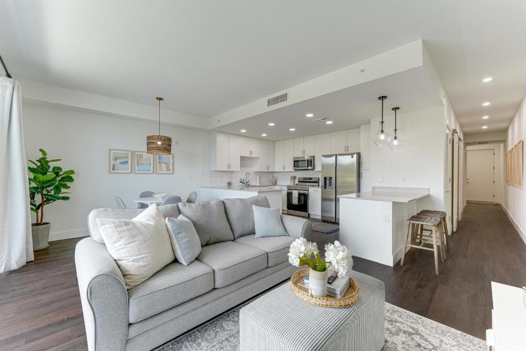 a white living room with a couch and a kitchen at All-New, Waterfront Condo in Downtown Sarasota! in Sarasota