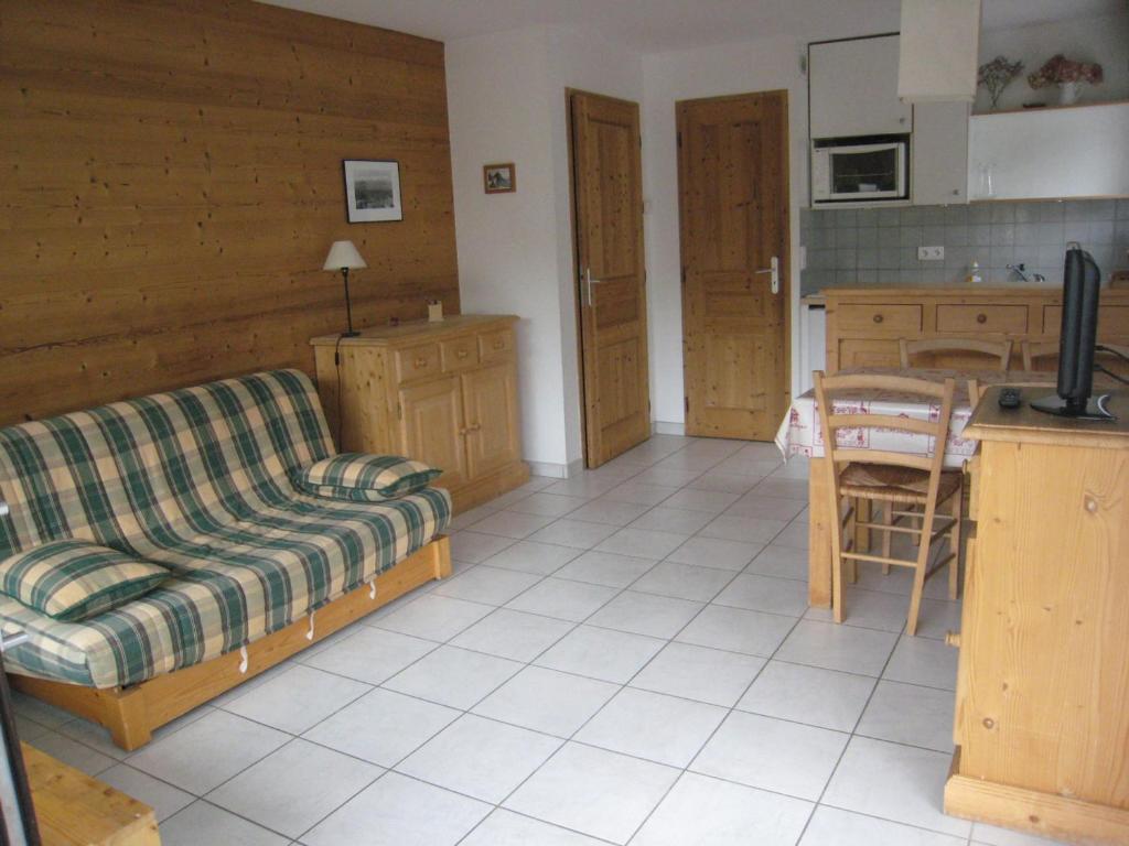 un salon avec un canapé et une cuisine dans l'établissement Appartement 4 Pers, Centre Village, Terrasse Sud - La Clusaz, Proche Commerces et Pistes - FR-1-459-85, à La Clusaz