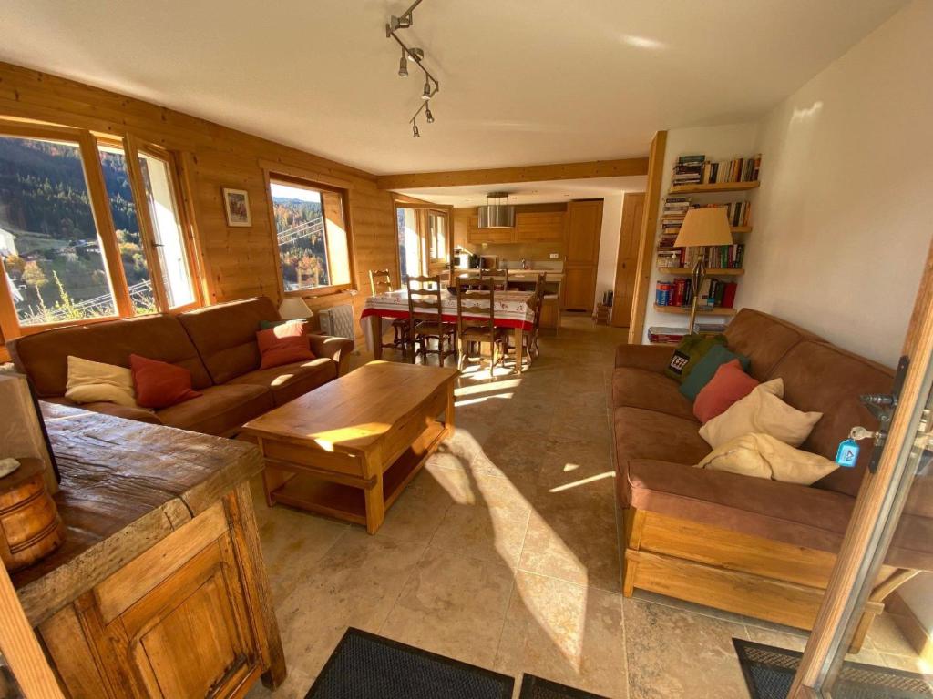 a living room with two couches and a table at Appartement La Clusaz, 4 pièces, 6 personnes - FR-1-459-179 in La Clusaz