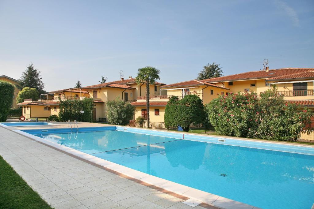 a large swimming pool in front of a house at Residence Primavera in Bardolino