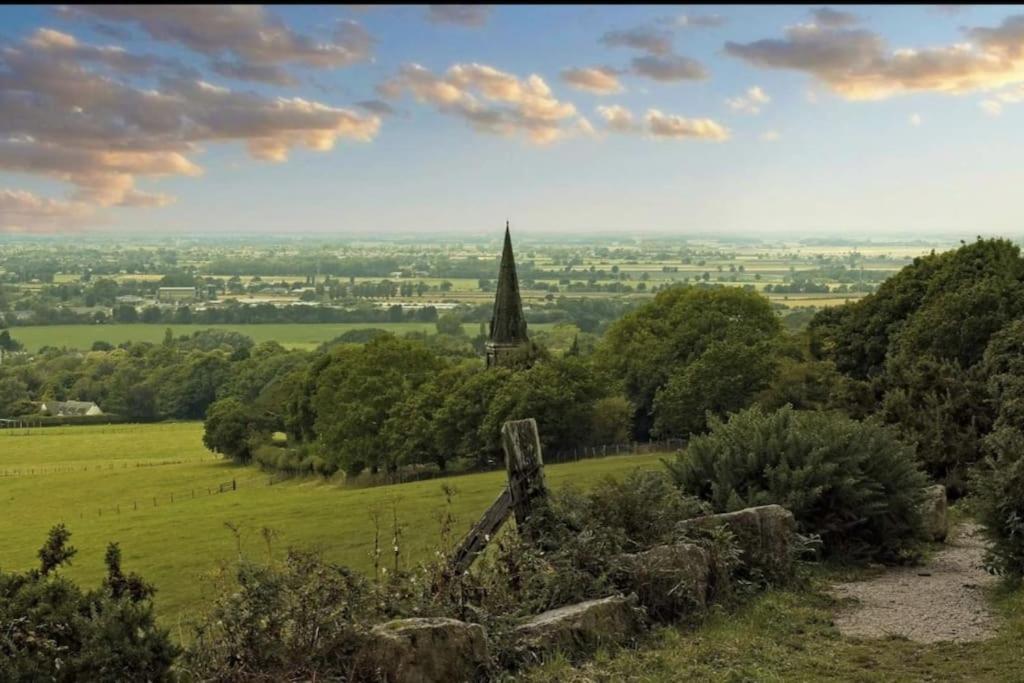 a view from a hill with a church in the distance at 'Mill Cottage' Parbold in Parbold