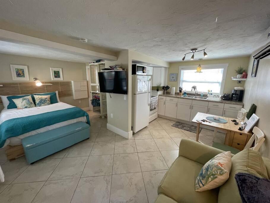a large bedroom with a bed and a kitchen at Cozy Beach Rental 1B/1B in St Pete Beach