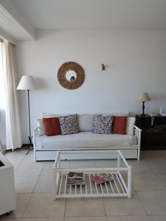 a living room with a white couch and a table at Peninsula in Punta del Este