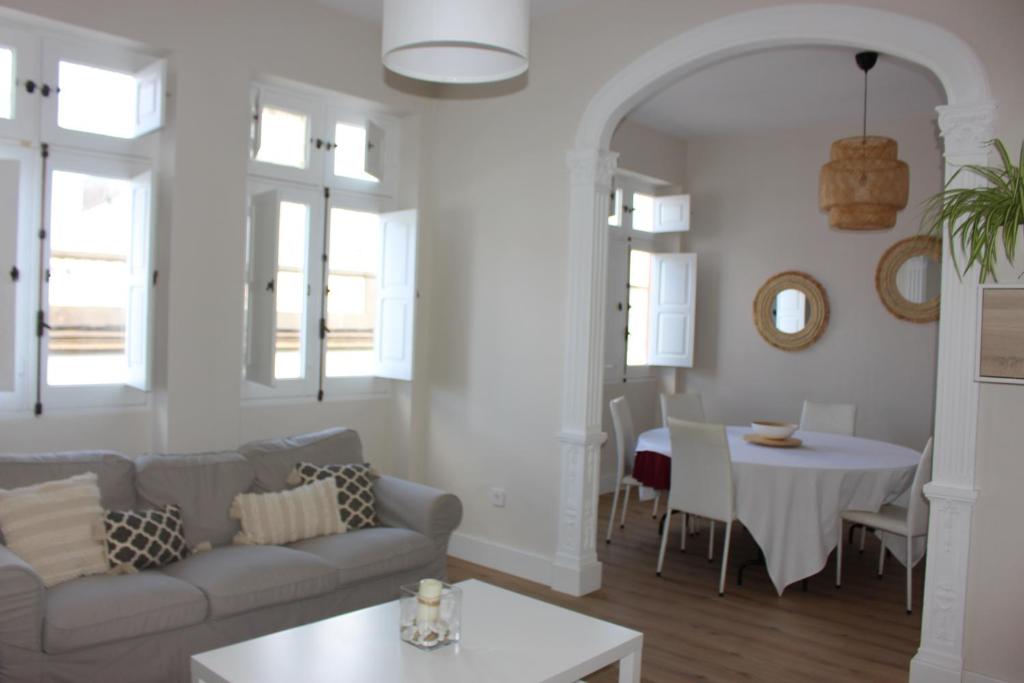 a living room with a couch and a table at La Casona de Galdós in Las Palmas de Gran Canaria