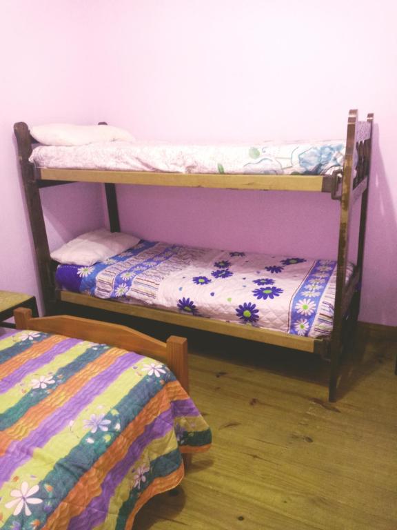 two bunk beds in a room with a bed at Hospedaje Violeta in Victoria