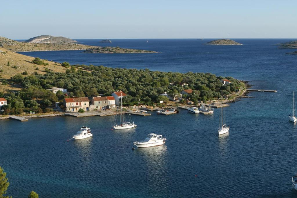 a group of boats in a body of water at Apartments & Stone cottage - National park Kornati in Vala