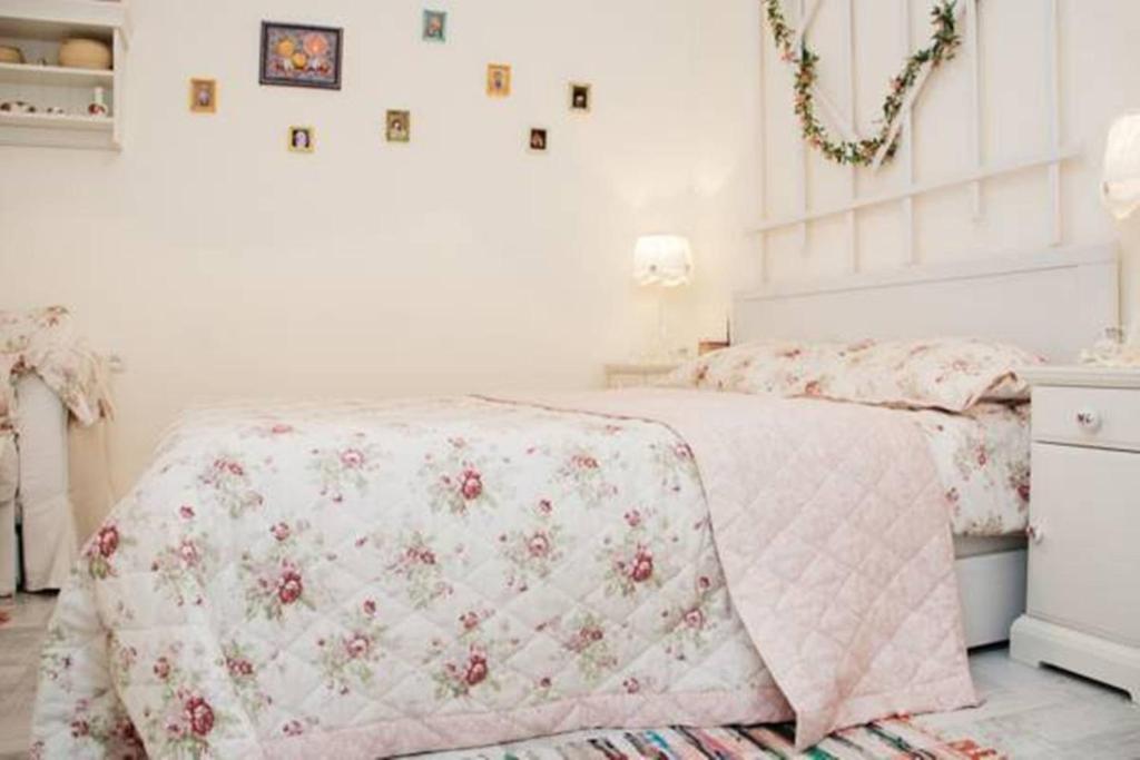 ein weißes Schlafzimmer mit einem Bett mit einer rosa Decke in der Unterkunft Romantic Apartment on Rynok square with Air-Conditioning in Lwiw
