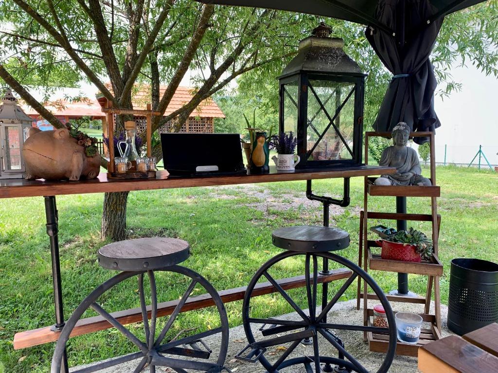 a table with a laptop and two bar stools at Brvnare Mrkic in Kremna