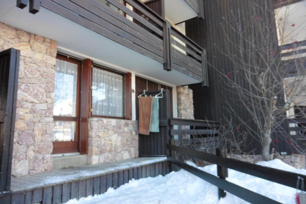 une terrasse couverte d'une maison dans la neige dans l'établissement studio à Risoul 1850 m, à Risoul