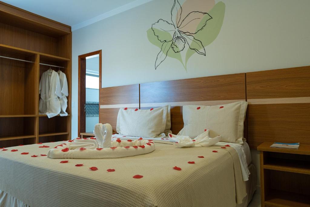 Postel nebo postele na pokoji v ubytování Orquídeas Praia Hotel